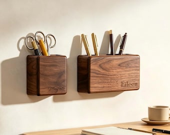 May include: Two rectangular dark wood wall-mounted organizers with rounded edges. The smaller organizer is engraved with the name Mustafa and holds scissors. The larger organizer is engraved with the name Eileen and holds several pens and pencils.