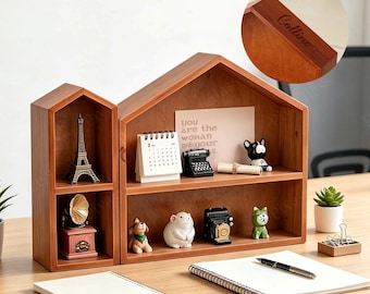 May include: A wooden house-shaped shelf unit with multiple compartments. The shelves display miniature Eiffel Tower, a gramophone, a calendar, a typewriter, and other decorative figurines. The text "You are the woman of your dreams" is visible on a pink card.