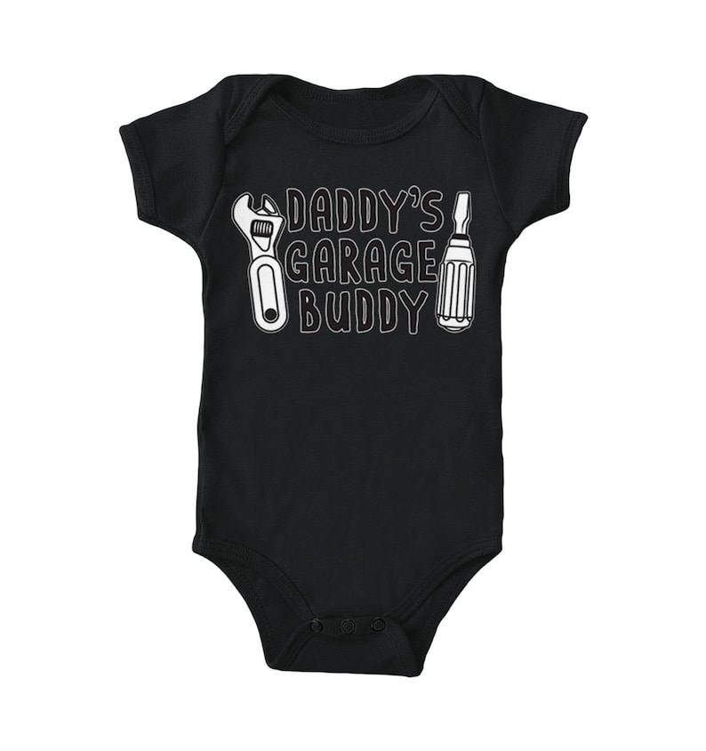 a baby bodysuit that says daddy's garage buddy