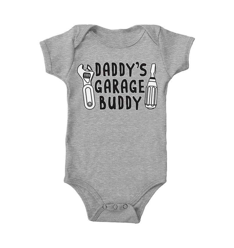 a baby bodysuit that says daddy's garage buddy