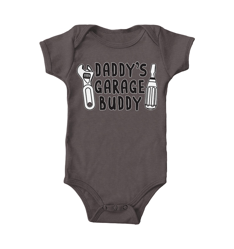 a baby bodysuit that says daddy's garage buddy