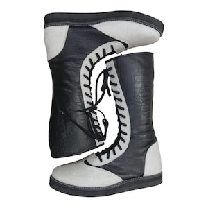 May include: Black and silver lace-up boots with a textured, crocodile-like pattern on the black leather. The boots have a silver glitter finish on the toe and heel, and a black sole.