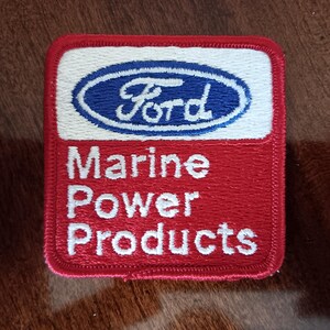 May include: A red, white, and blue embroidered patch with the Ford logo and the text "Marine Power Products".