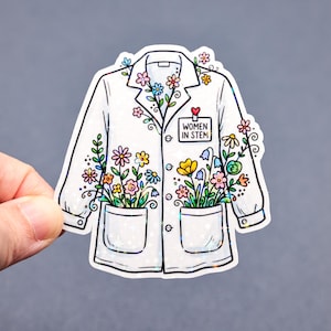 May include: A white lab coat sticker with colorful flowers and the text "WOMEN IN STEM." The sticker has a glittery, holographic effect. The coat's pockets and lapels are filled with various flowers in shades of pink, yellow, blue, and orange.