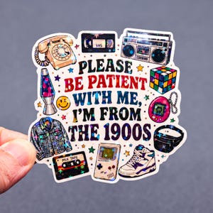 May include: A sticker with a collection of 1990s themed graphics, including a telephone, VHS tape, boombox, Rubik's Cube, lava lamp, denim jacket, cassette tape, Game Boy, sneaker, and a fanny pack. The text reads "PLEASE BE PATIENT WITH ME, I'M FROM THE 1900S."