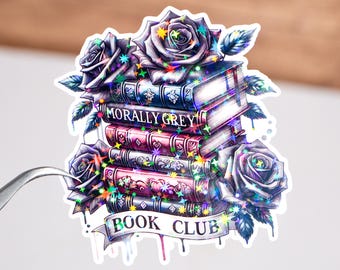 May include: A sticker with a stack of books, roses, and stars. The books have the text "Morally Grey" on the cover. The sticker also has the text "Book Club" on a banner.