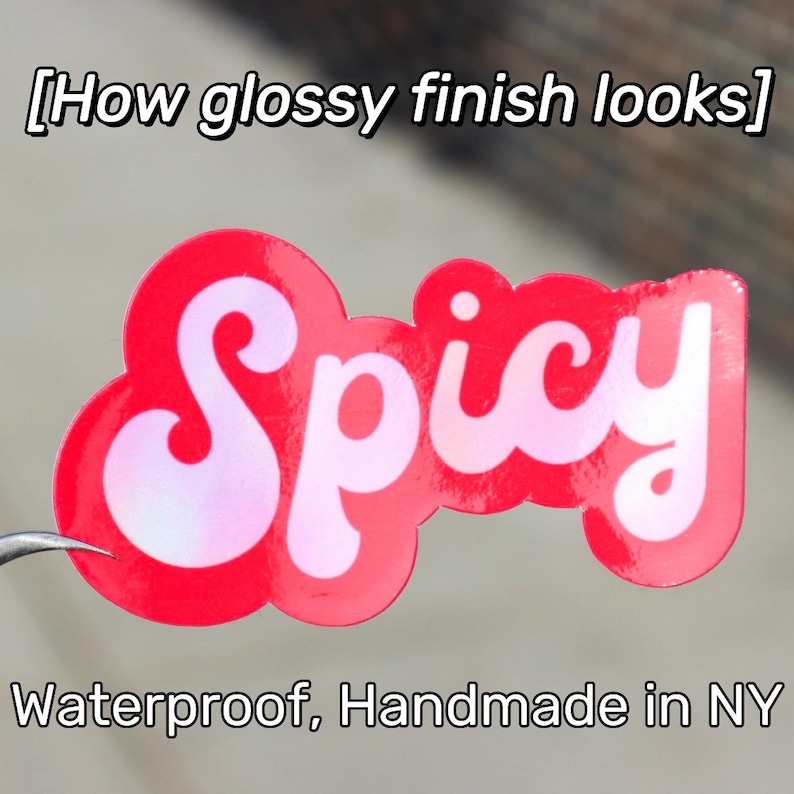 May include: A glossy red sticker with the word "Spicy" in white script. The sticker has a cloud-like shape and the text "Waterproof, Handmade in NY" is below the sticker.