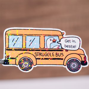 May include: A yellow school bus with a goose driving and the text "Get in, bestie!" on the side. The bus is covered in iridescent glitter and says "Struggle Bus" on the front.