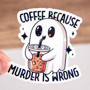 May include: A white ghost with a cute face is holding a cup of iced coffee. The text on the sticker reads "Coffee because murder is wrong."