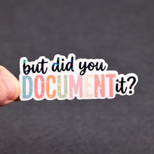 May include: A rectangular sticker with the text "but did you DOCUMENT it?" in black and colorful letters. The word "DOCUMENT" is in pastel colors with star accents. The sticker has a holographic, iridescent sheen.