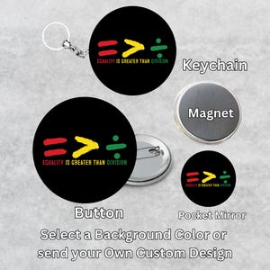 May include: A set of customisable buttons, magnets, and keychains featuring a black background with a red, yellow, and green graphic design. The graphic design includes the text "Equality is greater than division" and the symbols "==>".