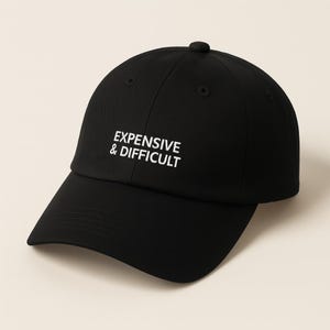 Black baseball cap with the text "EXPENSIVE & DIFFICULT" in white block letters.