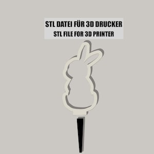 Puede incluir: Un modelo de conejo blanco imprimible en 3D con orejas largas. El modelo está diseñado para ser impreso en una impresora 3D. El texto "STL FILE FOR 3D PRINTER" es visible en la imagen.