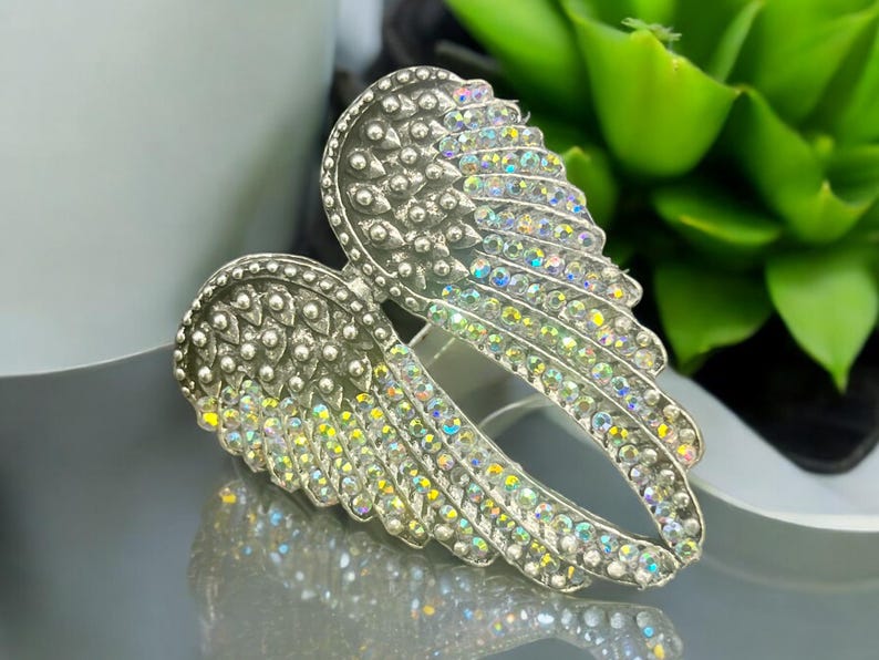 Angel Wing Statement Ring – Size 8 alloy ring with crystal rhinestones. Measures 3x4x2 cm, 13 oz. Trendy and lightweight, perfect for adding a touch of glam to any outfit. Ideal for fashion lovers and makes a great gift.