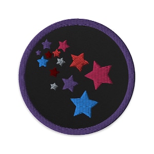 May include: Embroidered patch with a black centre and a purple border. The patch features a design of colourful stars in shades of red, pink, blue, purple, and silver.