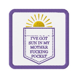 May include: Embroidered patch with a white background and a purple border. The design features a yellow sun above a pocket graphic with the text "I'VE GOT SUN IN MY MOTHER FUCKING POCKET" in purple.