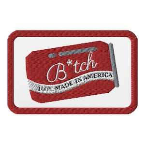 May include: Embroidered patch with a red background and white border. The patch features the word "B*tch" in cursive, with the text "100% MADE IN AMERICA" below. The design resembles a retro soda can.