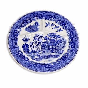 May include: A round, divided plate with a blue and white Willow pattern design. The plate features three sections and a detailed border. The central design depicts a landscape with buildings, bridges, and birds.