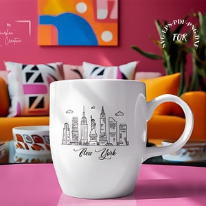 May include: White ceramic mug with a black line drawing of the New York City skyline, including the Statue of Liberty, and the text "New York".