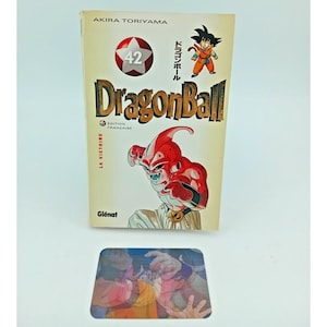 Puede incluir: Manga Dragon Ball volumen 42 de Akira Toriyama. La portada presenta una ilustración roja y blanca de un personaje, el número 42 en un círculo rojo y el título "DragonBall". El libro está en francés y es una edición Glénat.