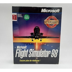 May include: A Microsoft Flight Simulator 98 software box. The box features a graphic of a plane taking off at sunset. The Microsoft logo is at the top, with the words "Flight Simulator 98" prominently displayed. The box also includes the text "Encore plus de réalisme!"