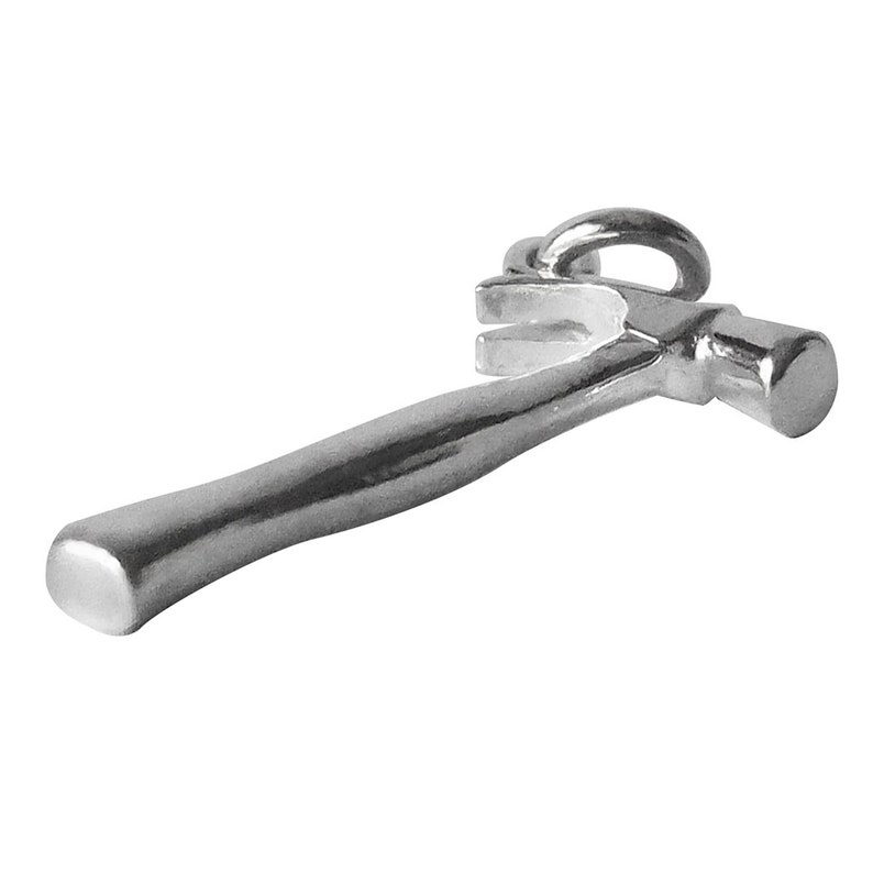 May include: A silver hammer charm with a claw and a loop for attaching to a chain or bracelet.