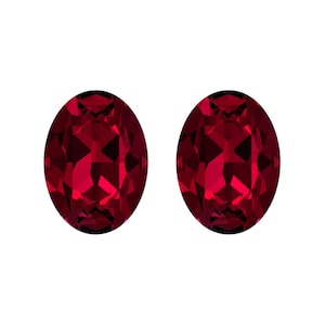 May include: Two oval-shaped red gemstones with a faceted cut.