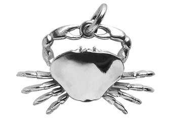 May include: A silver charm in the shape of a crab. The charm is detailed with claws and a body.