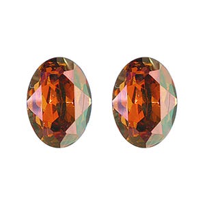 May include: A pair of oval-shaped earrings with a faceted, iridescent finish. The earrings are a deep amber colour with hints of green and red.