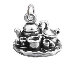 May include: A silver charm depicting a tea set with a teapot, creamer, sugar bowl, and two teacups on a tray.