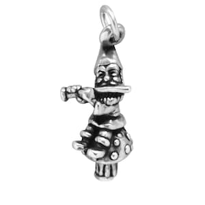 May include: A silver charm of a gnome playing a flute while sitting on a mushroom.