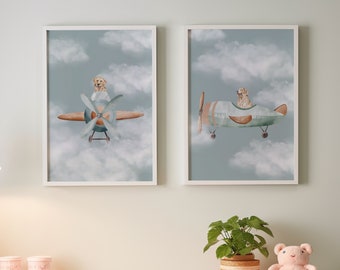 May include: Two framed prints with a light blue background and white clouds. Each print features a cartoon dog flying a small airplane. The dog in the left print is wearing a pilot's hat and goggles. The dog in the right print is wearing a pilot's hat.