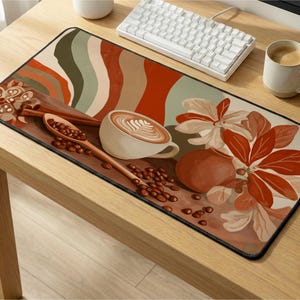 May include: A rectangular mouse pad with a coffee-themed design. The pad features a latte, coffee beans, a wooden spoon, and floral elements in shades of brown, orange, and cream. The design is set against a backdrop of abstract shapes.