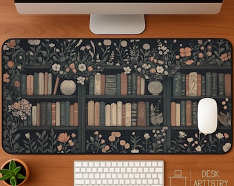 May include: A rectangular desk mat featuring a bookshelf design with books, flowers, and vases. The mat has a black background with a floral pattern and a white mouse. A keyboard and a small potted plant are also visible.