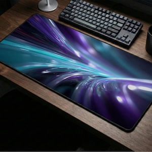 May include: A rectangular mouse pad with a vibrant abstract design in shades of teal, purple, and white. The pad is on a wooden desk, next to a black keyboard, mouse, and mug.