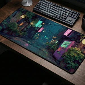May include: A rectangular mouse mat with a digital painting of a neon-lit cityscape at night. The design includes neon signs, greenery, and a wet street, creating a moody scene. A black keyboard, mouse, and mug are on a wooden desk.