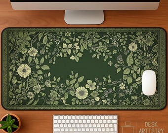 May include: A rectangular desk mat featuring a dark green background with a detailed botanical pattern of light green flowers, leaves, and vines. The mat has a decorative border and a smooth surface, with a white computer mouse resting on the right side.