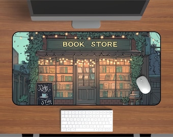 May include: A rectangular desk mat featuring a detailed illustration of a bookshop storefront at dusk. The shop has large glass windows filled with rows of books, illuminated by warm string lights. The text BOOK STORE is printed above the entrance.