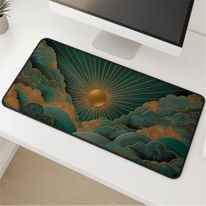 May include: A rectangular desk mat featuring a graphic design of a golden sun with radiating beams set against a dark teal background. The scene includes stylized, layered clouds in shades of teal, green, and gold with a stippled texture.