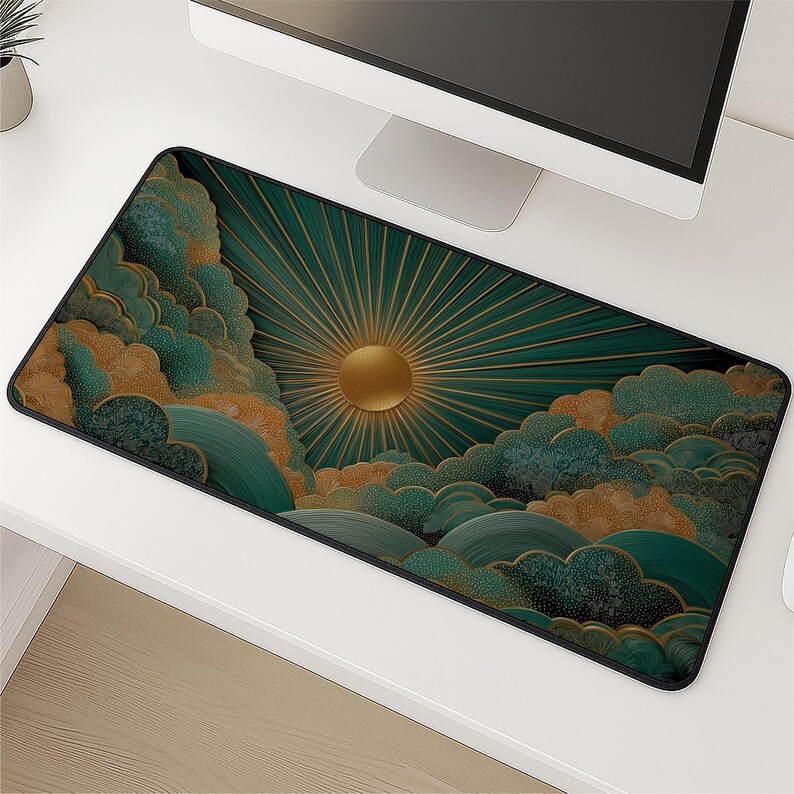 May include: A rectangular desk mat featuring a graphic design of a golden sun with radiating beams set against a dark teal background. The scene includes stylized, layered clouds in shades of teal, green, and gold with a stippled texture.