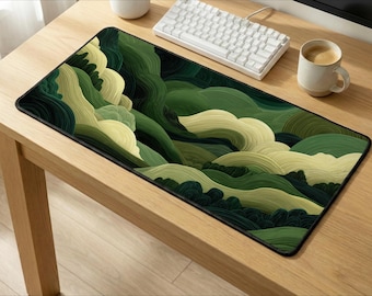 May include: A rectangular desk mat featuring a layered, abstract landscape design in shades of forest green, olive, and pale cream. The surface displays a series of curved, flowing lines that create a topographical, wave-like pattern across the entire mat.