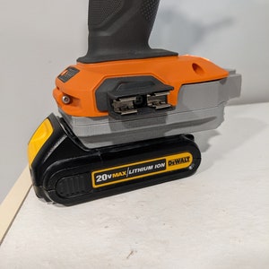 May include: A black and yellow 20V MAX lithium-ion battery for a DeWalt power tool. The battery is connected to the tool, which is not visible in the image.