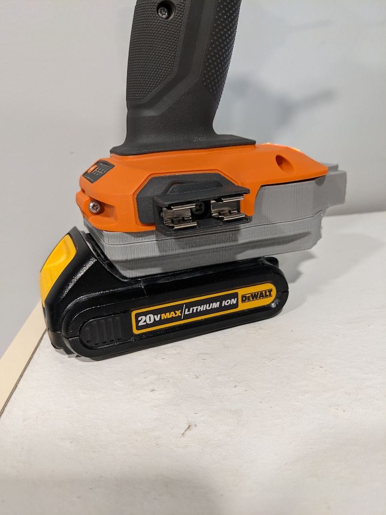 May include: A black and yellow 20V MAX lithium-ion battery for a DeWalt power tool. The battery is connected to the tool, which is not visible in the image.