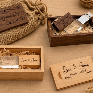 May include: Two wooden USB flash drives with clear acrylic ends, each housed in a matching wooden box filled with wood shavings. One drive is engraved with "Our Wedding Day" and the other with "Ben & Anna" and "March 1, 2025" with leaf accents.