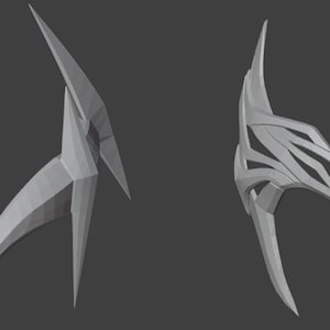 Puede incluir: Dos máscaras impresas en 3D, una con un diseño de cara completa y la otra con un diseño de cara parcial. Ambas máscaras están hechas de plástico gris y tienen un diseño afilado y angular.