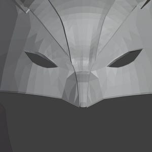 K&ouml;nnte beinhalten: Nahaufnahme einer grauen, geometrischen Maske mit zwei Augenl&ouml;chern. Die Maske besteht aus einem strukturierten Material und hat ein scharfes, kantiges Design.