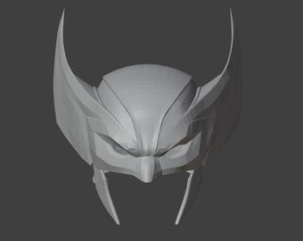 Op de afbeelding: Een grijs 3D-geprint model van een superheldenhelm met een puntige bovenkant en twee grote oorstukken.