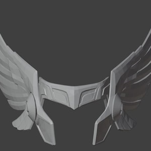 May include: A gray 3D printed helmet with wings. The helmet has a wide, flat top and a curved front. The wings are attached to the sides of the helmet and are spread out.