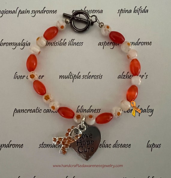 Omg-id do anything for this charm & orange beads! #CRPS Awareness** Coral  Glass beads w/ 