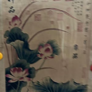 May include: A vintage-style painting featuring lotus flowers with pink petals and large green leaves. The artwork has Chinese characters in the upper left corner and along the right side, set against a beige background.